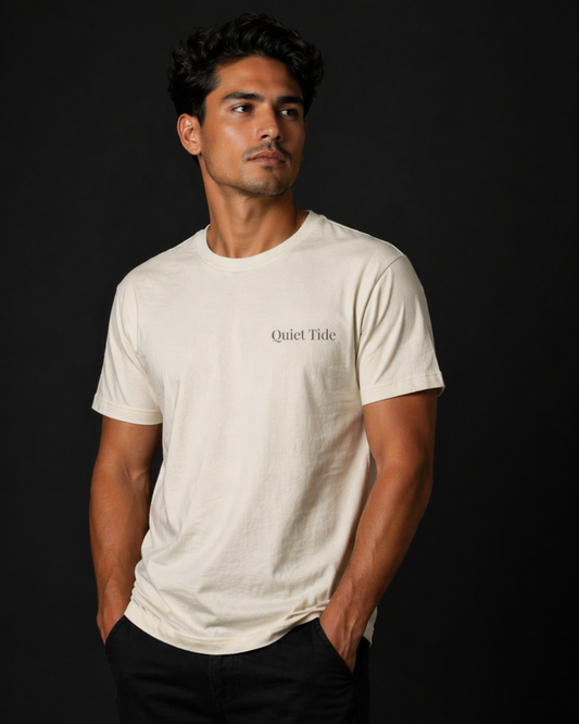 Man wearing Quiet Tide natural t-shirt back view with “Quiet Tide” text on black background