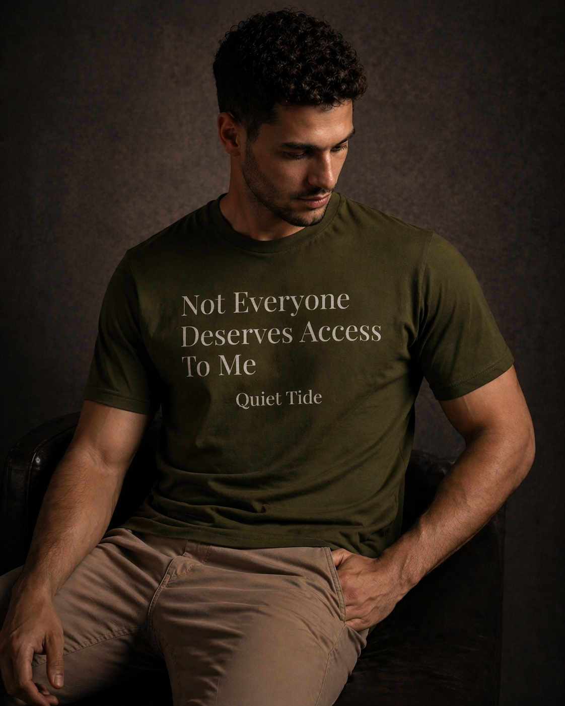 Man wearing olive Quiet Tide t-shirt with ‘Not Everyone Deserves Access To Me’ text on front