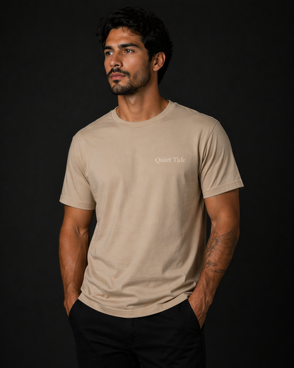 man wearing quiet tide tan calm statement tee front view black background